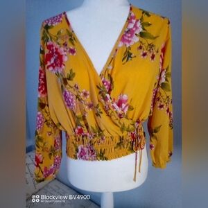 Candie's yellow flowered v- neck blouse with stretch band & tie. Size small